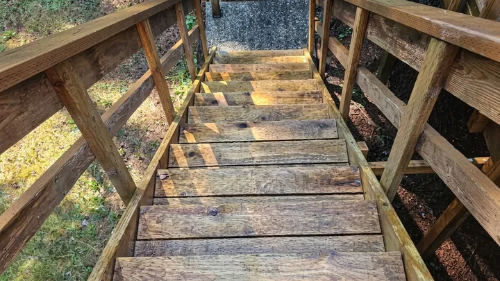 Wood deck staircase restored to a warm, natural finish after pressure washing in Bellevue, WA