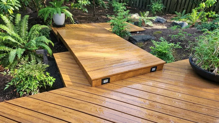 Wood deck platform restored to a golden, natural finish after pressure washing in Kirkland, WA