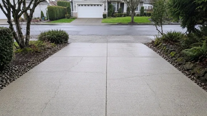 Clean, moss-free concrete driveway after pressure washing in Bellevue, WA
