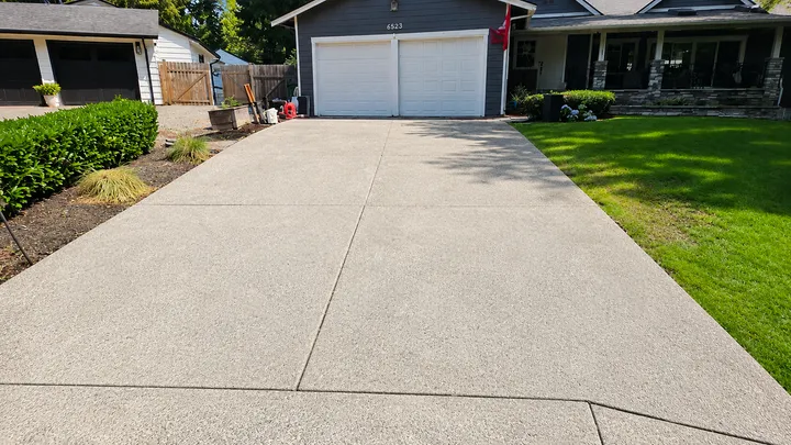 Concrete driveway restored to a bright, even finish after pressure washing in Issaquah, WA