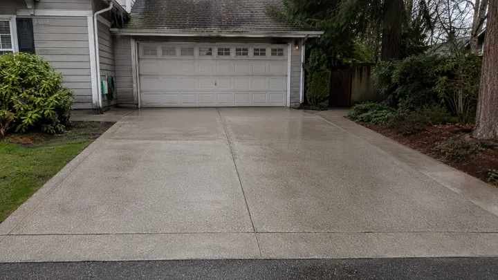 Concrete driveway restored to a clean, even finish after pressure washing in Sammamish, WA
