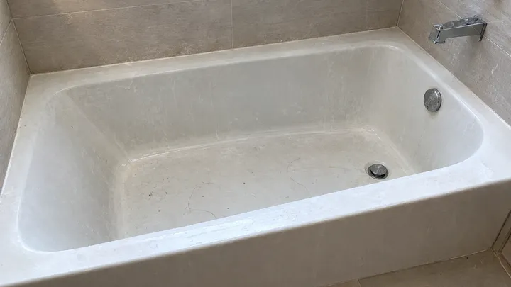 Bathtub coated in soap scum and grime before a move-out clean in Issaquah, WA
