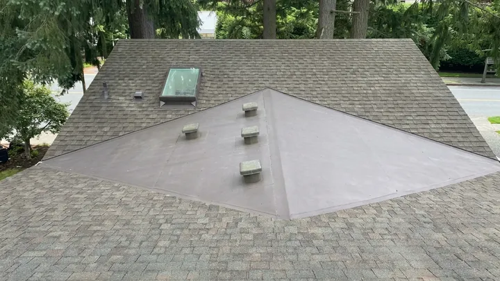 Asphalt shingle roof cleared of moss and debris after soft-wash roof cleaning in Sammamish, WA