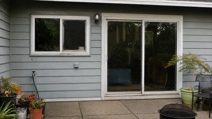 Streaky, dust-covered window and sliding glass door before cleaning in Issaquah, WA
