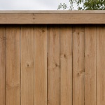 Wood fence with light dust and dirt before pressure washing
