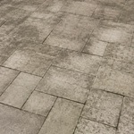 Weathered backyard paver patio with moss and algae before pressure washing
