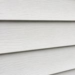 House siding with some dust and dirt before washing